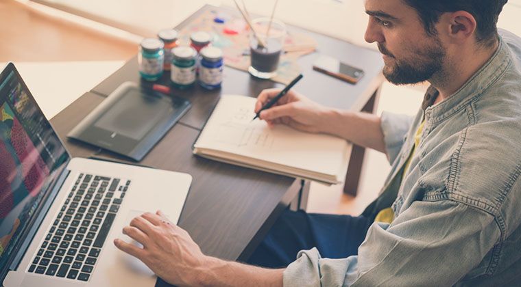 handsome hipster modern man working home using laptop PHP coding